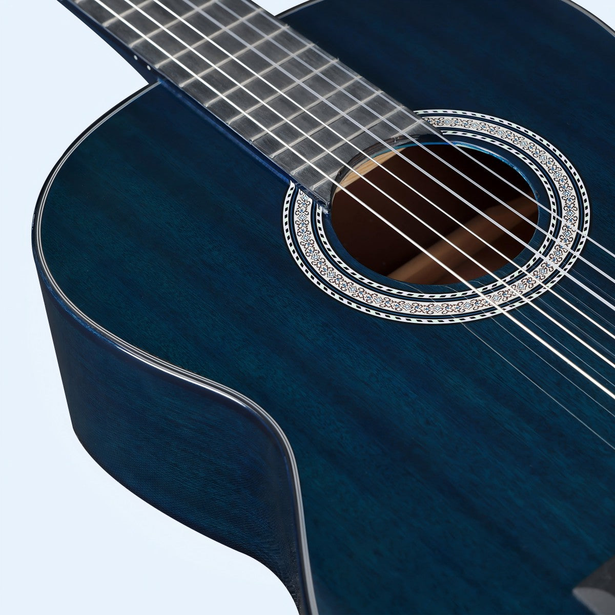 WINZZ beginner guitar displayed with the footstool and capo for added functionality.